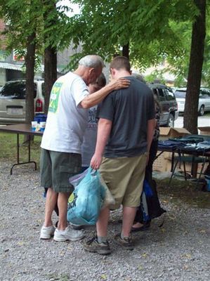 Dick Brooks praying w/this family
